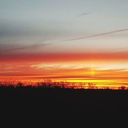 Silhouette landscape against sky during sunset