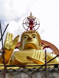 Low angle view of statue against temple building