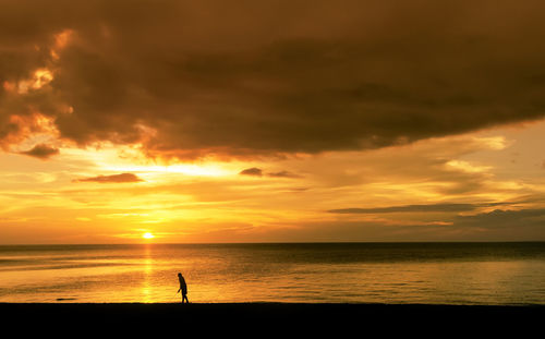 Scenic view of sea against orange sky