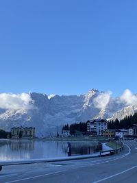 Scenic view of snowcapped mountains against blue sky