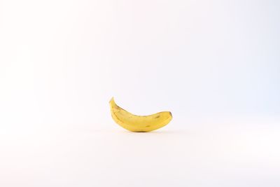 Close-up of yellow fruit against white background