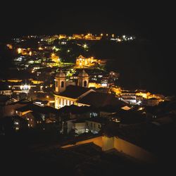 High angle view of illuminated buildings in city at night