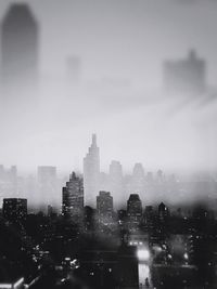 Illuminated cityscape against sky at night