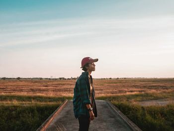 Full length side view of man standing on field