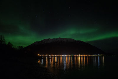 Scenic view of lake against sky at night