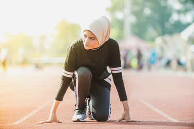 Female athlete exercising on track