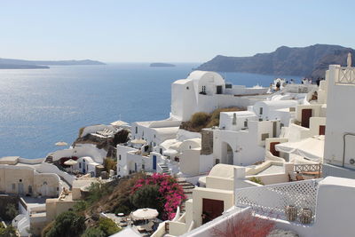 High angle view of townscape by sea against sky