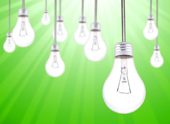 Close-up of light bulbs hanging on glass