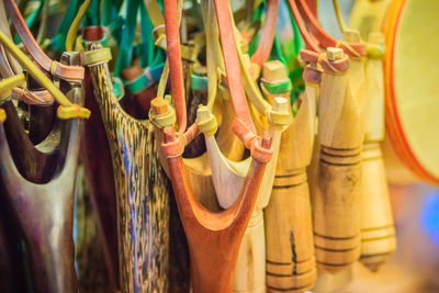 Close-up of multi colored clothes hanging on wood