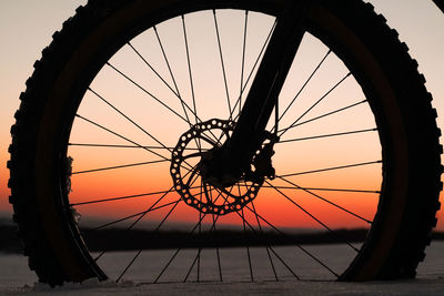 Silhouette ferris wheel against sky during sunset