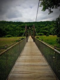 Narrow footbridge along landscape