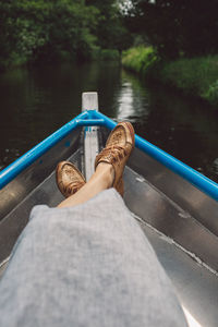 Side view of woman sitting on boat