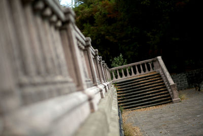 Close-up of old bench in park