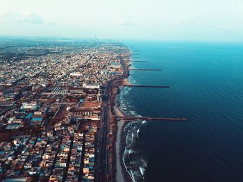 High angle view of buildings by sea against sky