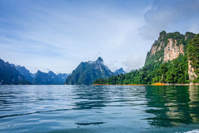 Scenic view of lake and mountains against sky