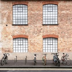 Bicycle parked against buildings on footpath