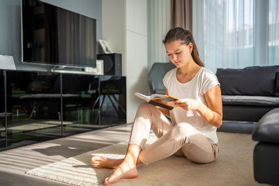 Young woman using laptop at home