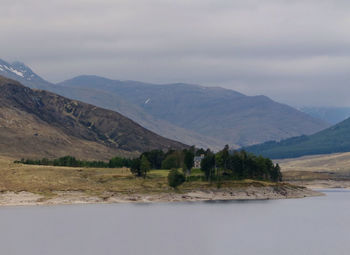 Scenic view of mountains against cloudy sky