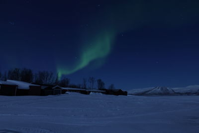 Scenic view of snow covered landscape against sky at night