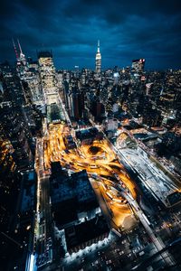 High angle view of city lit up at night