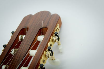 Close-up of guitar against white background