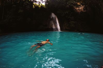 Man swimming at kawasan falls