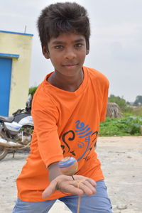 Portrait of boy holding outdoors