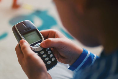 Midsection of man using mobile phone