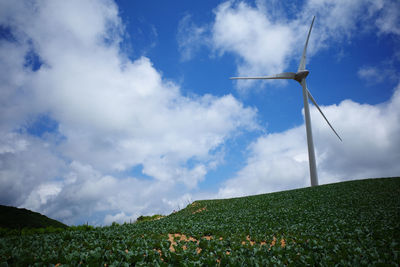 Windmill on field against sky