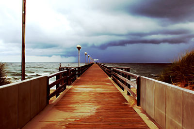 Pier over sea against sky