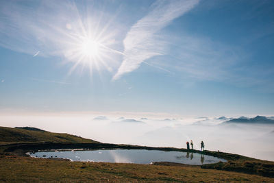 Scenic view of mountains against bright sun