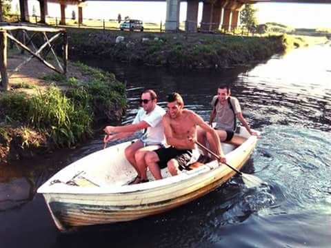 water, lifestyles, sitting, leisure activity, relaxation, nautical vessel, day, men, person, boat, outdoors, high angle view, river, nature, young adult, casual clothing