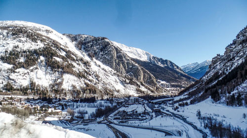 Scenic view of snowcapped mountains against clear sky