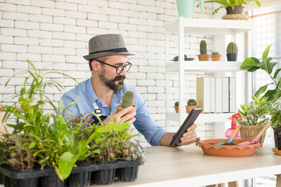 Young man using mobile phone while sitting at home