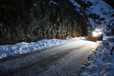 Snow covered road at night