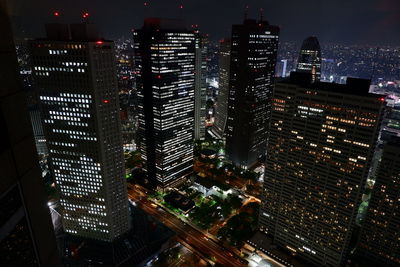 Aerial view of illuminated buildings in city at night