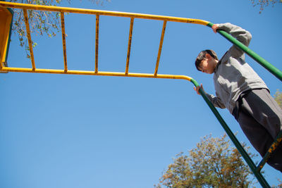 Low angle portrait of little boy in playground