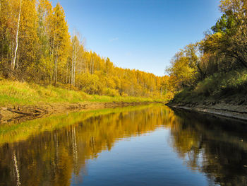 Scenic view of lake by trees against sky during autumn