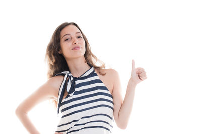 Portrait of smiling young woman against white background