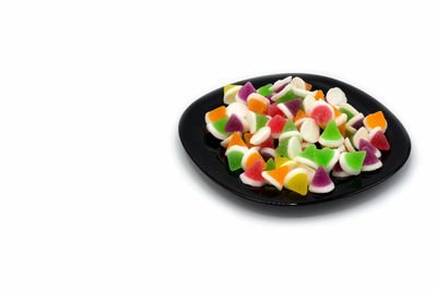 High angle view of multi colored candies against white background