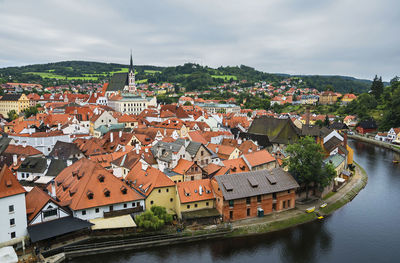 High angle view of houses in town against sky