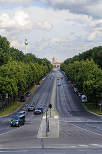 Cars on road in city against sky