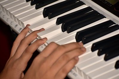 Midsection of man playing piano