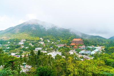 Scenic view of townscape and mountains against sky