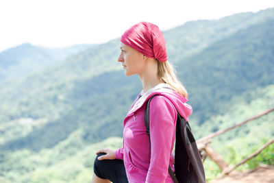 Side view of woman looking at mountain