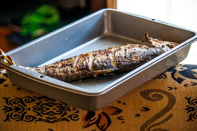 Close-up of fish in tray on table