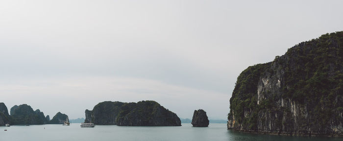 Rock formations by sea against sky