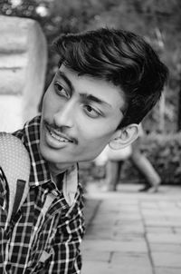 Portrait of smiling young man sitting outdoors