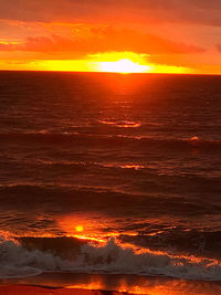 Scenic view of sea against romantic sky at sunset