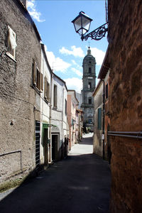 Street amidst buildings against sky